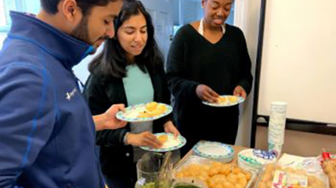 people selecting food from table