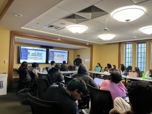 Duke South Asian studies librarian, Adhitya Dhanapal, speaking to a group of Duke Hindi students in a library room