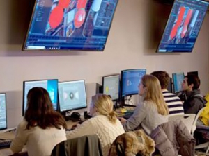students in game lab looking at monitors