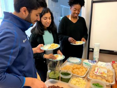 people selecting food from table
